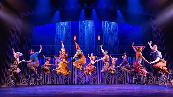 A musical theater ensemble performs a musical number.