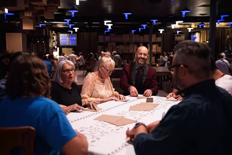 Image: People sit at a table