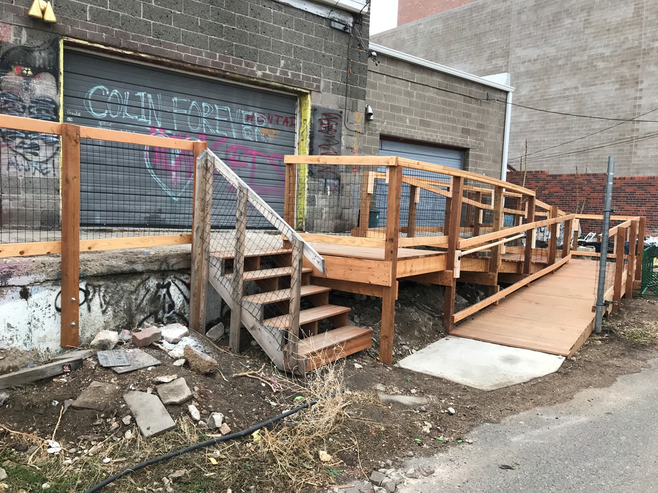 A wheelchair ramp now replaces the old loading dock outside Rhinoceropolis and Glob. A tribute to the late Colin Ward is spray-painted on the garage.