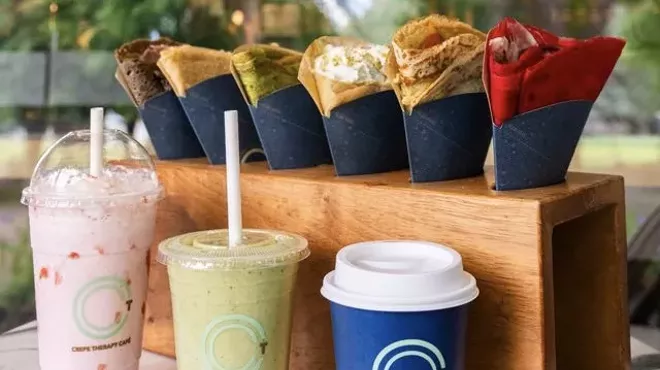 Various crepes and beverages from Crepe Therapy Cafe displayed on a white marble table