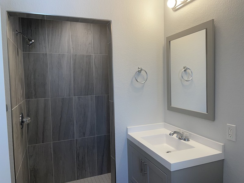 The bathrooms are designed with accessibility in mind, including these walk-in showers.