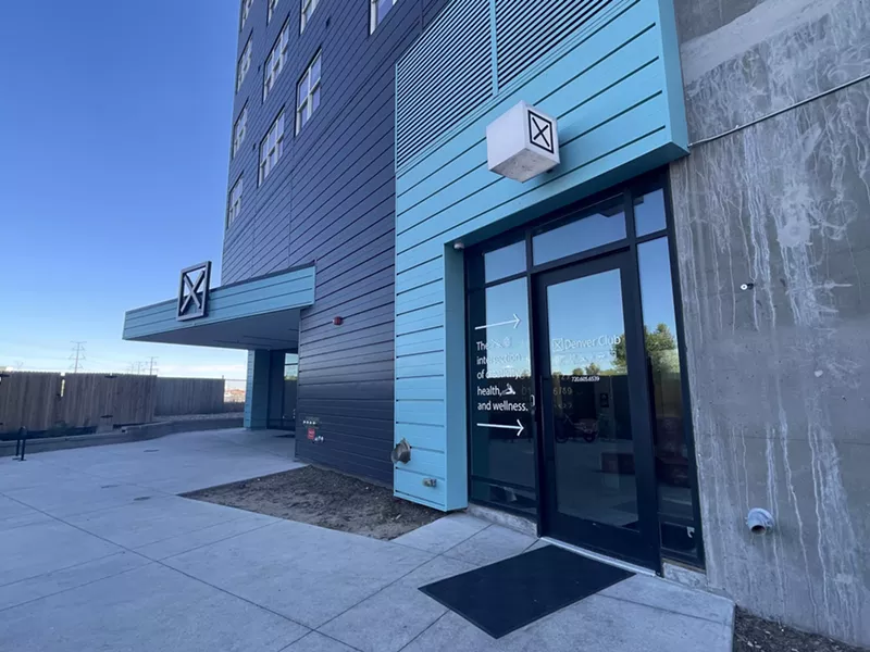 Image: A turquoise and black building.