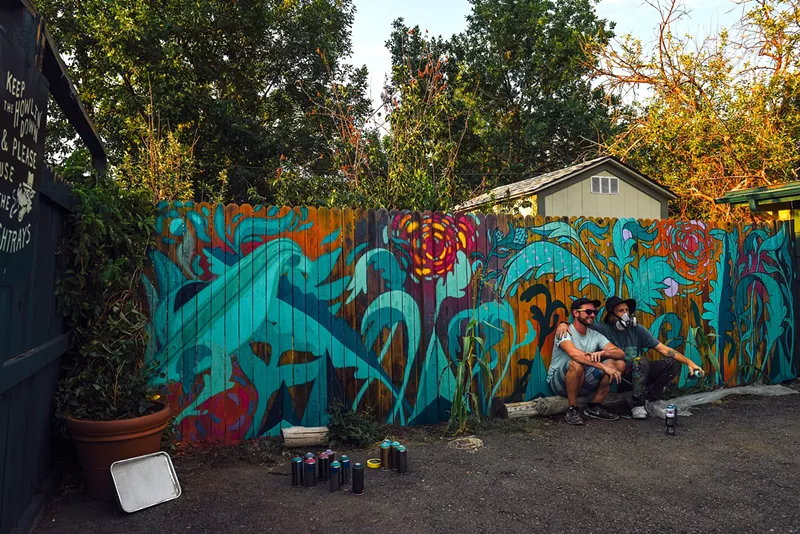 Image: RUMTUM and Pat Milbery pause for a photo mid-paint outside of Fort Greene.