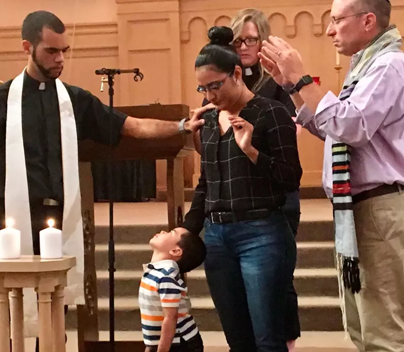 Image: Ministers pray with Araceli Velasquez during her welcoming ceremony in August.