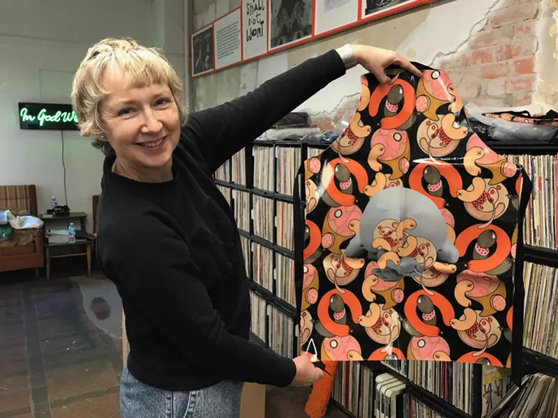 Image: Sarah Staton shows off an artist-designed apron.