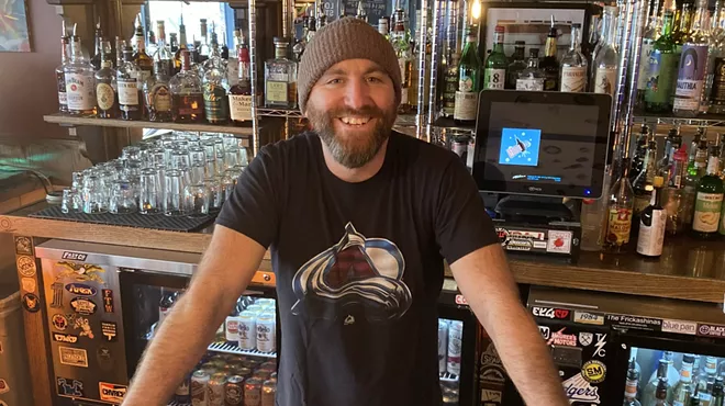 Michael John standing behind a bar.