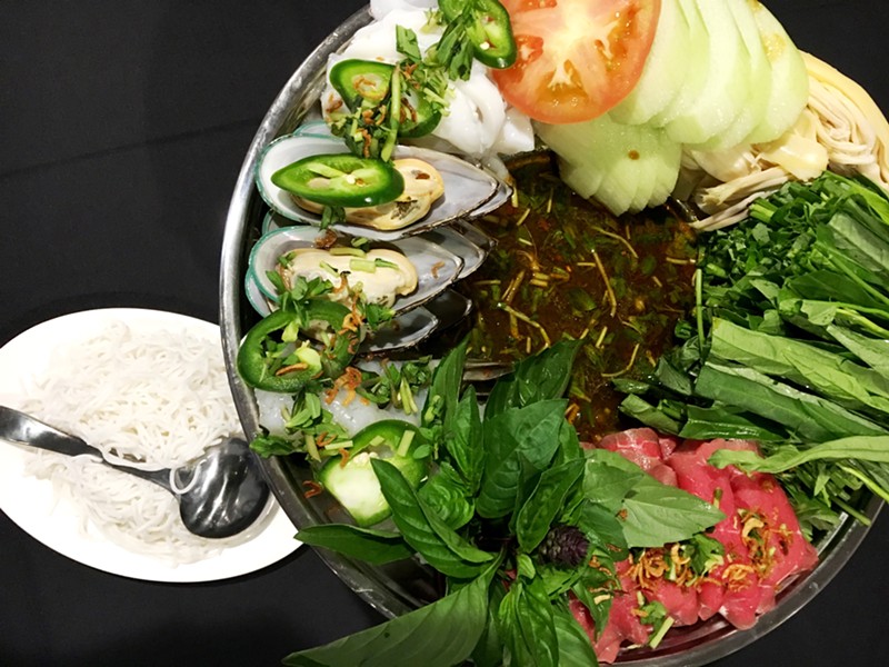 Hot pot with beef, mussels, squid and fresh vegetables at Savory Vietnam.