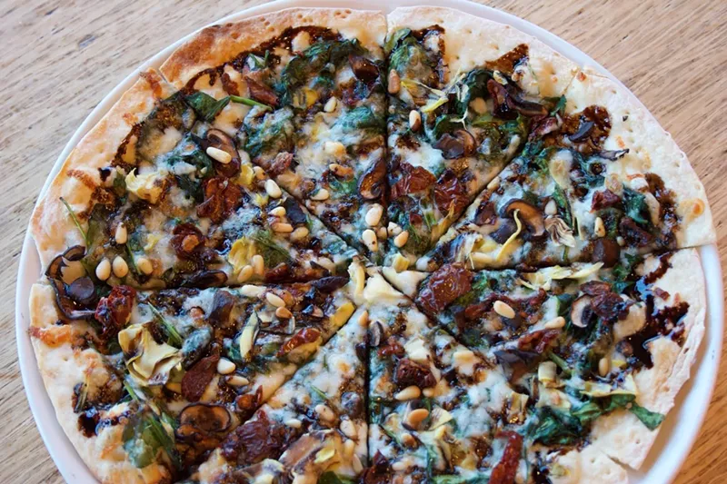 Image: The Verdi pizza, with garlic oil. spinach, sun-dried tomatoes, artichoke hearts, pine nuts and roasted criminis.
