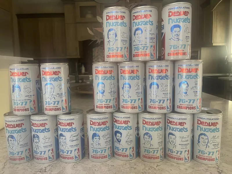 Image: Seventeen white pepsi cans depicting basketball players outlined in blue.