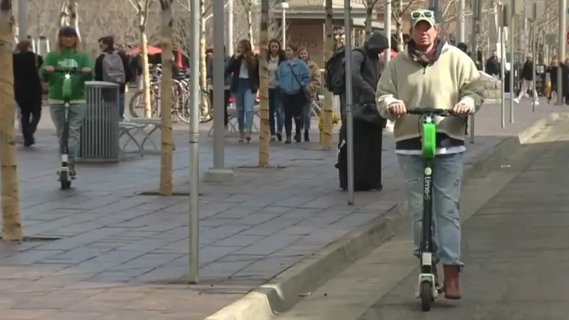 Image: Both of the people on e-scooters seen here were riding legally in March, when the image was captured. Now, only the person in the bike lane is following current regulations.