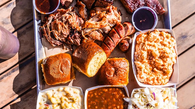a platter of barbecue meats and sides