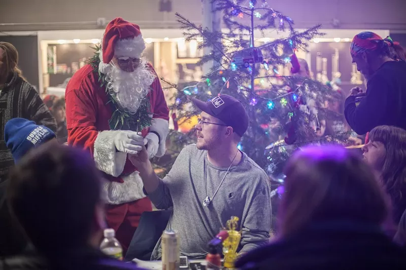 Image: Santa Clause gifting marijuana in front of a Christmas tree