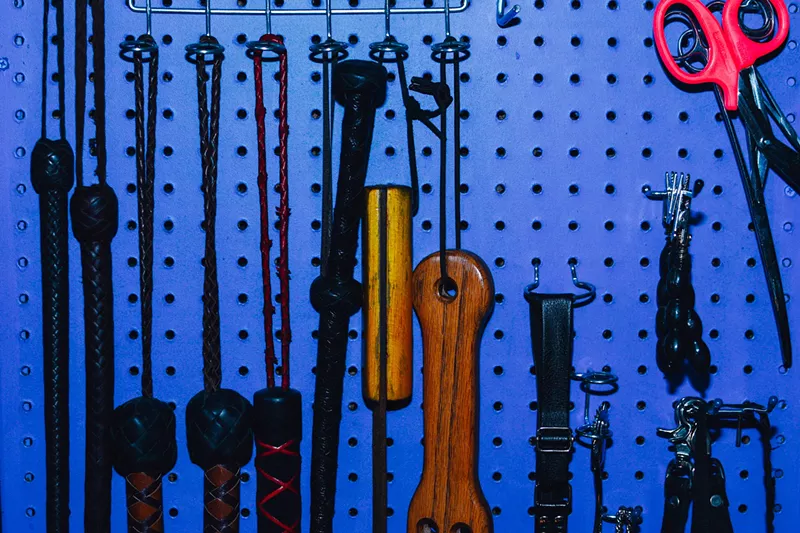 Image: wall of BDSM gear and sex toys