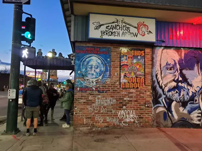 Image: a brick wall with graffiti and street art