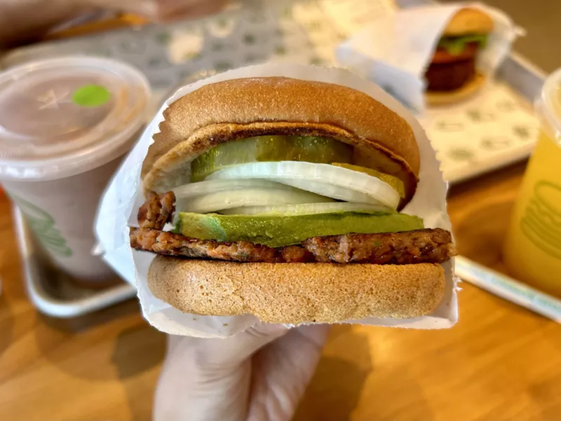 Image: hand holding a hamburger