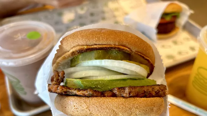 hand holding a hamburger