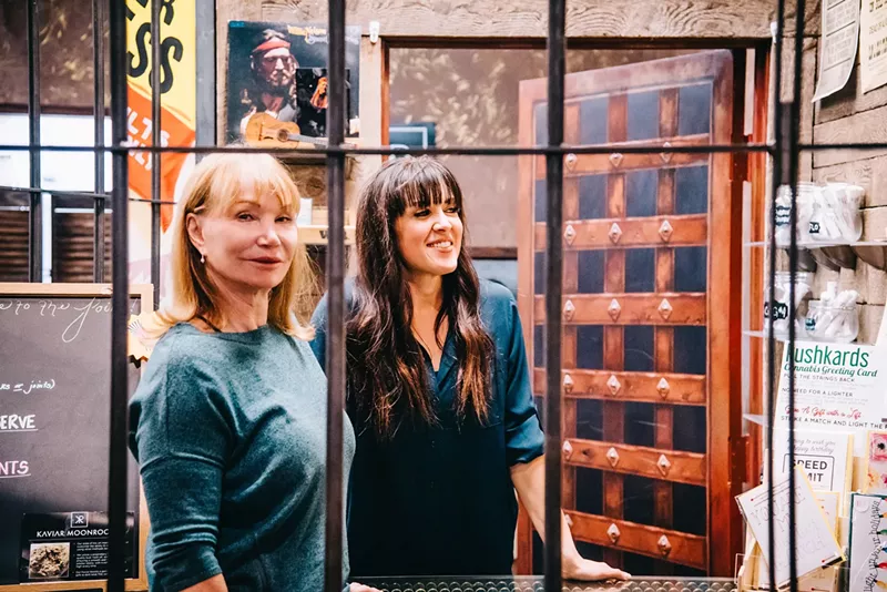 Image: Smokin Gun Apothecary owner Deborah Dunafon (left) also owns the strip club next door.