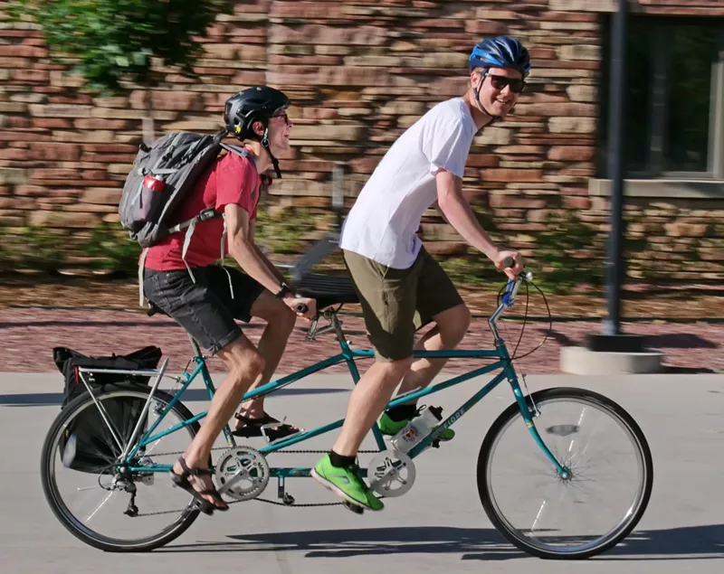 Image: Two people riding on a tandem bicycle in Boulder