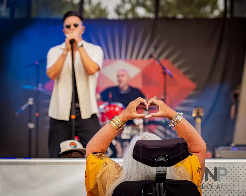 Image: woman in wheel chair watching music
