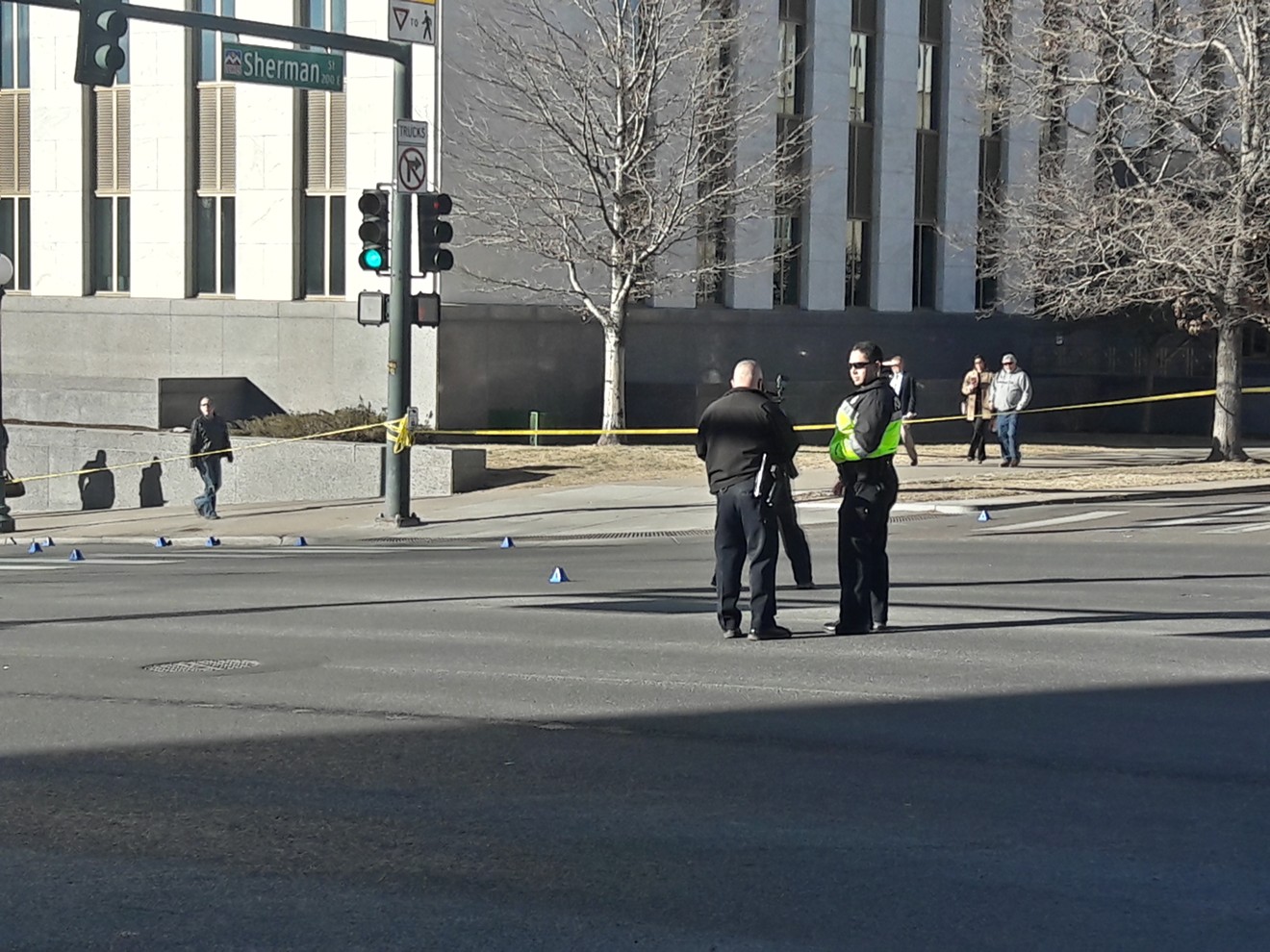 Police scattered blue triangles marking crime-scene evidence near the Capitol.