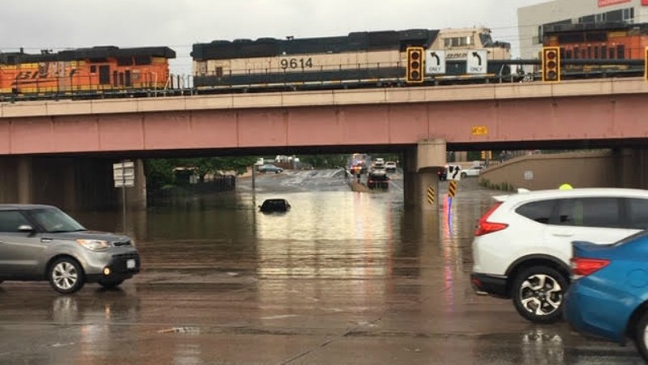 A car submerged in a street flood caused by a giant sinkhole on July 1.