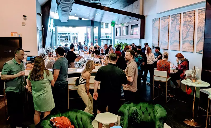 Image: crowd of people inside a bar