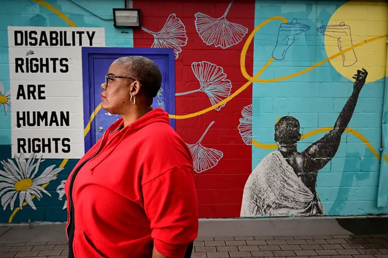 Image: woman standing in front of an art installation