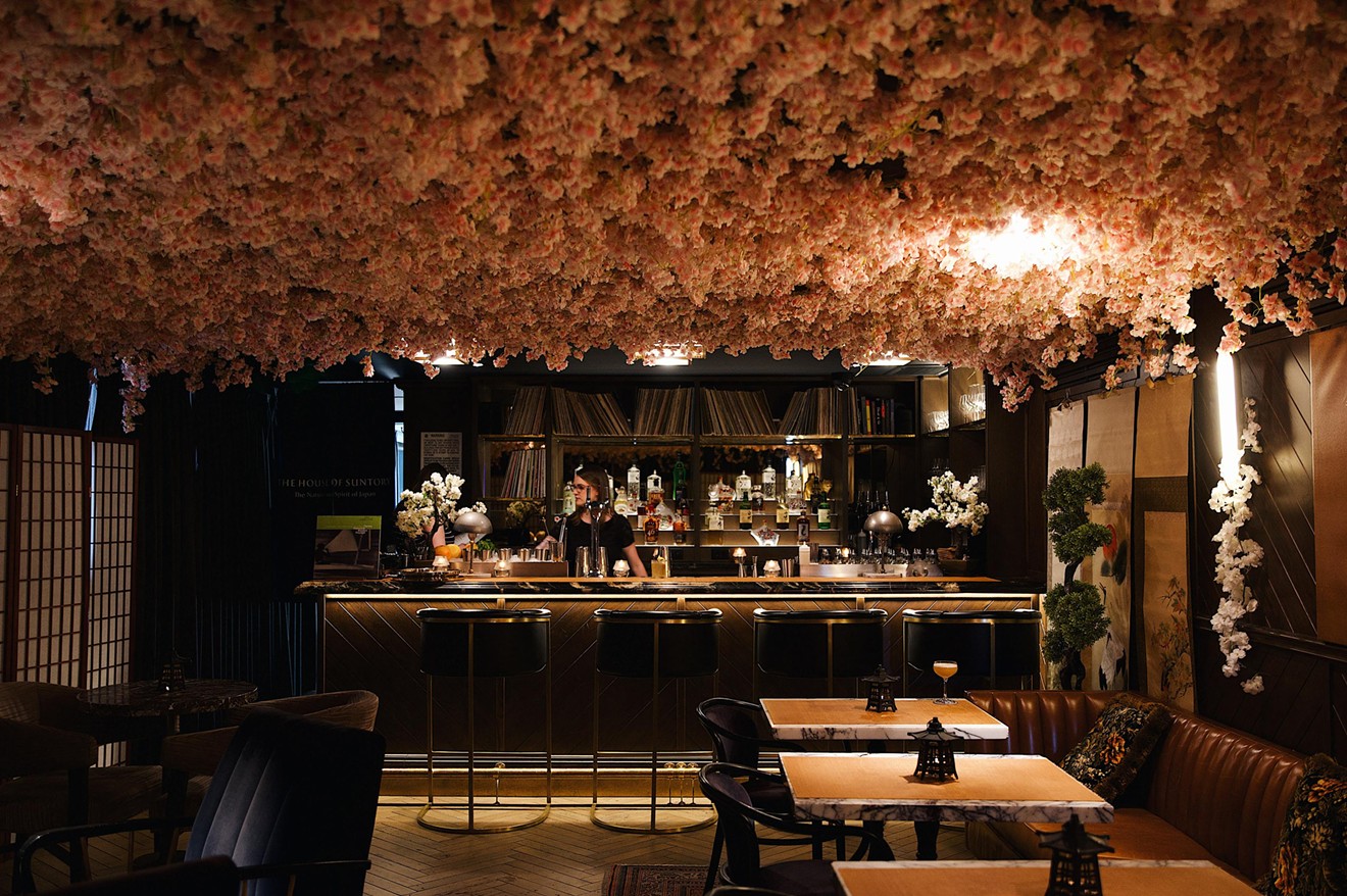 Hundreds of faux cherry blossoms hang from the ceiling of Sakura Blossom Bar.