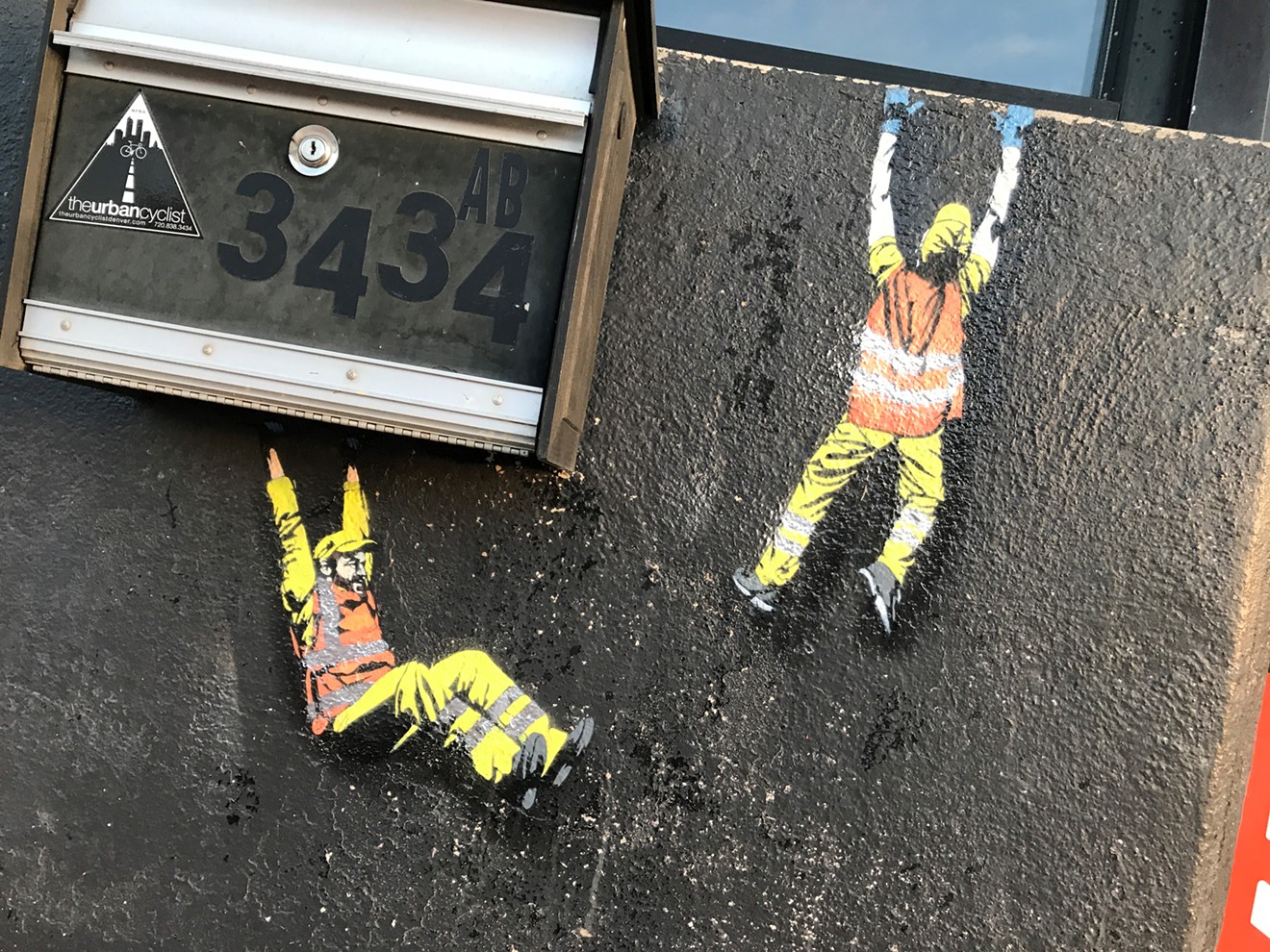 Jaune Marion stenciled these workers along Brighton Boulevard.