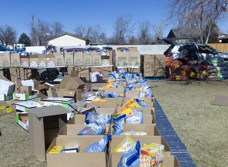 Boxes of food are packed and loaded into cars at Falcon Park each week in Montbello, which regularly draws a line of cars stretching for multiple blocks.