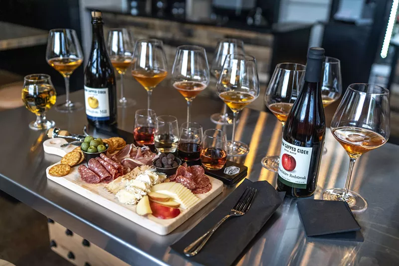 Image: Charcuterie board along with cider and glassware.