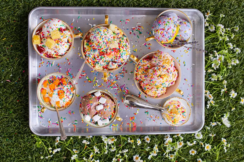 Image: an overhead shot of scoops of ice cream in cups covered in sprinkles