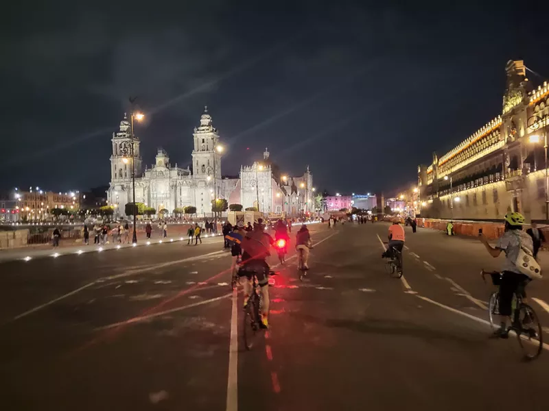 Image: A man rides a bike through Mexico City