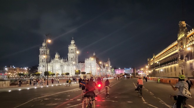 A man rides a bike through Mexico City