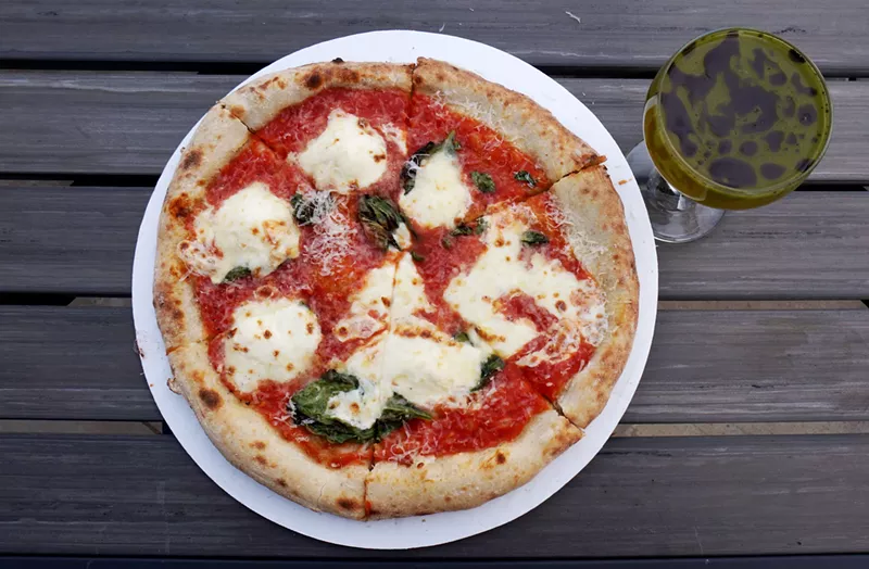 Image: A Margherita pizza from Sprezzatura with a crazy cocktail from the bar at Rocker Spirits.