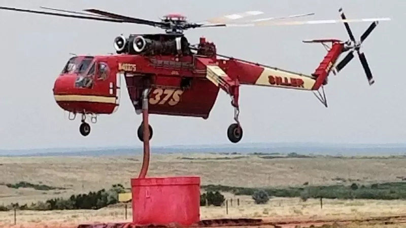 Image: A "sky crane" prepares for a water drop on the Spring Creek fire.
