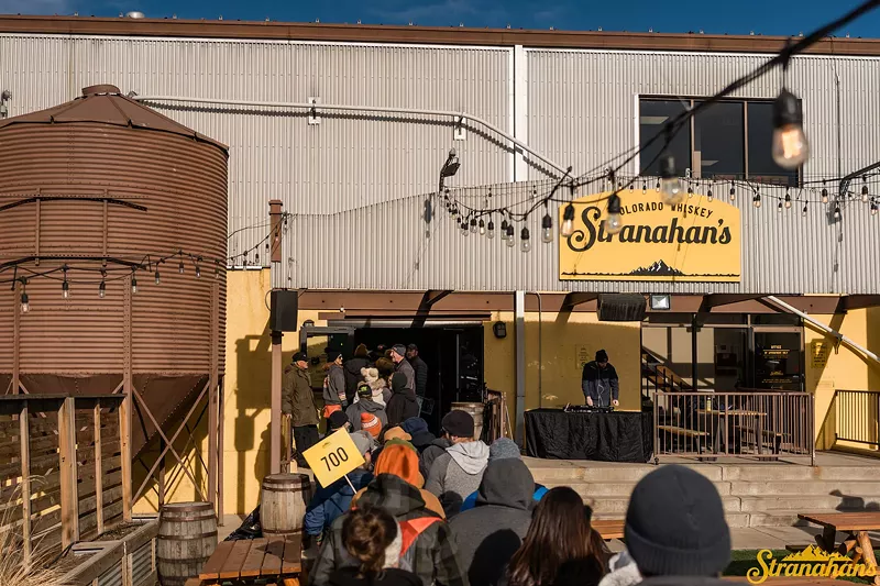 Image: crowd lined up outside a distiller