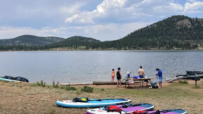 Paddleboards and a group of people along the shore at Wellington Lake