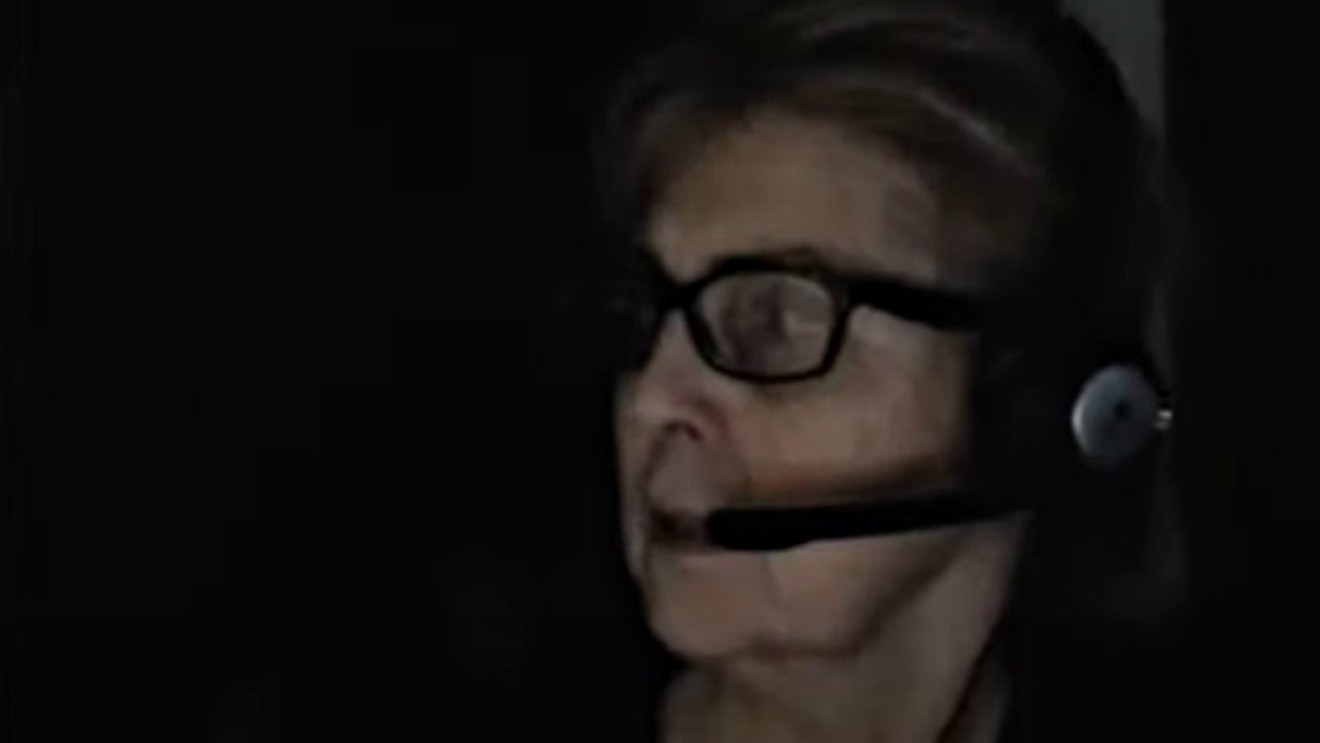 Susan Holmes turning toward police officers tasked with arresting her during a live-stream broadcast on February 4.
