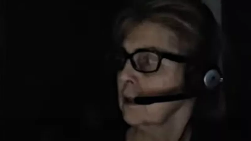 Image: Susan Holmes turning toward police officers tasked with arresting her during a live-stream broadcast on February 4.