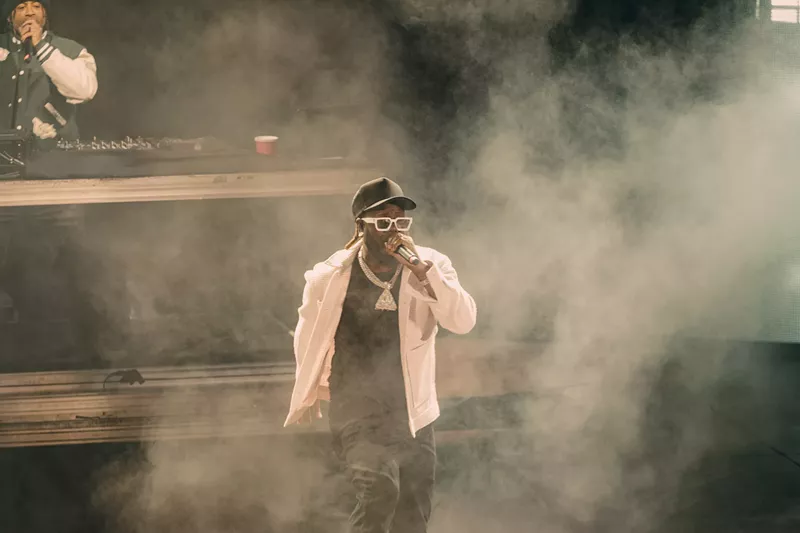 Image: A photo of T-Pain on stage performing at Red Rocks in Morrison, Colorado.