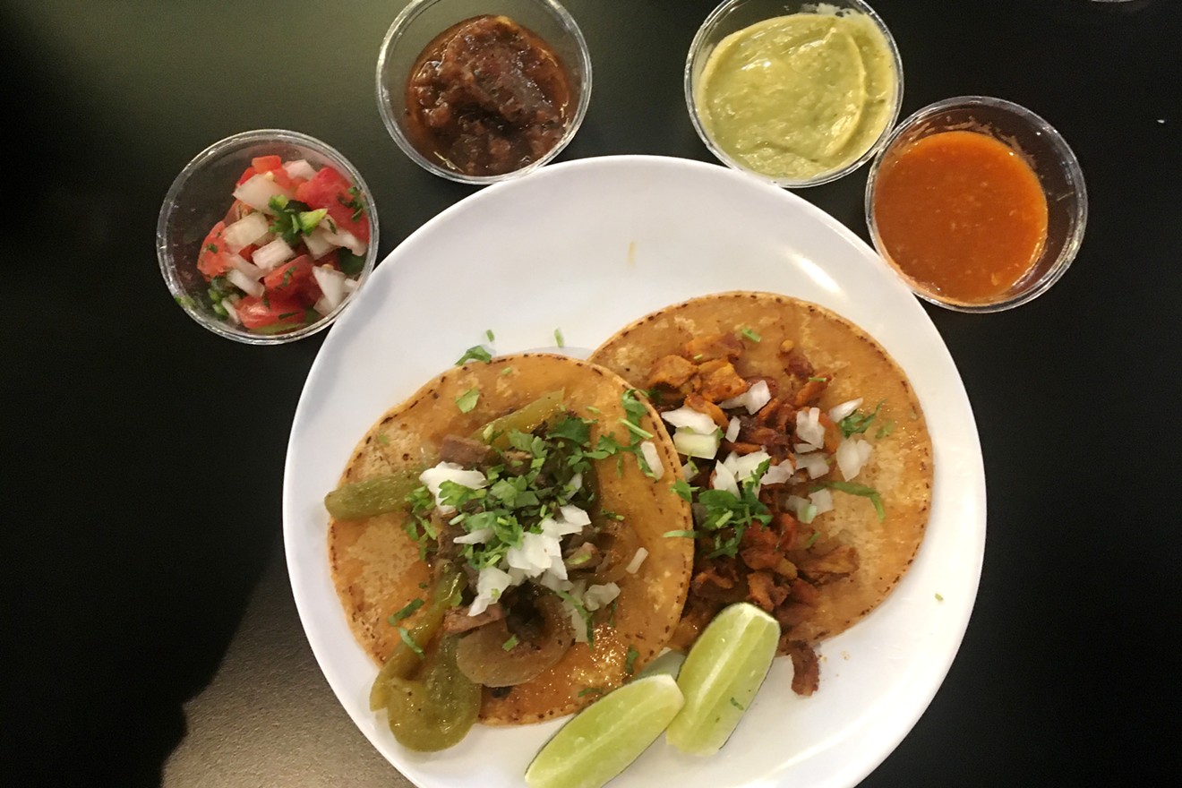 Carne asada and pastor tacos with housemade salsas at Tacos Al Chile.