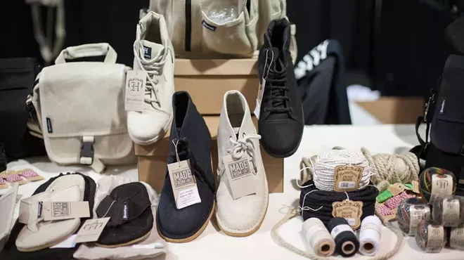A wide selection of shoes are on display at a store.