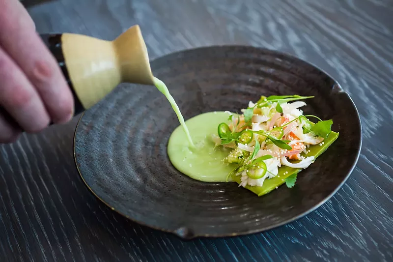 Image: King crab with avocado, pickled shallot, serrano chiles, puffed rice and coconut-chile broth.