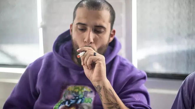 man takes hit off a joint