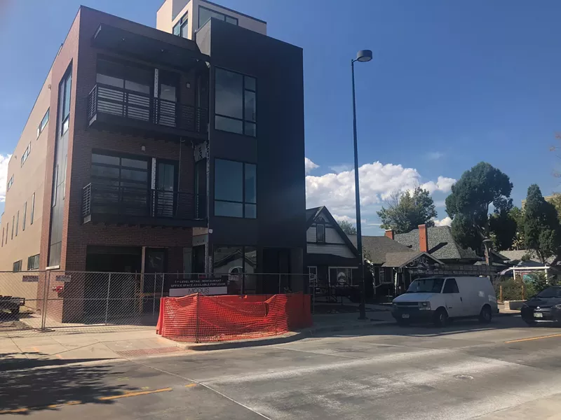 Image: A new mixed-use development towers over two historic bungalows slated for demolition on Tennyson Street.
