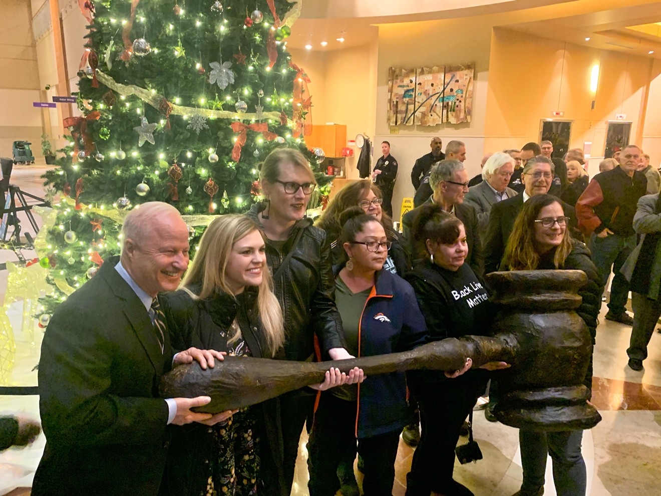 Activists posed with their giant gavel before an Aurora City Council meeting. Mike Coffman hopped in for a photo.