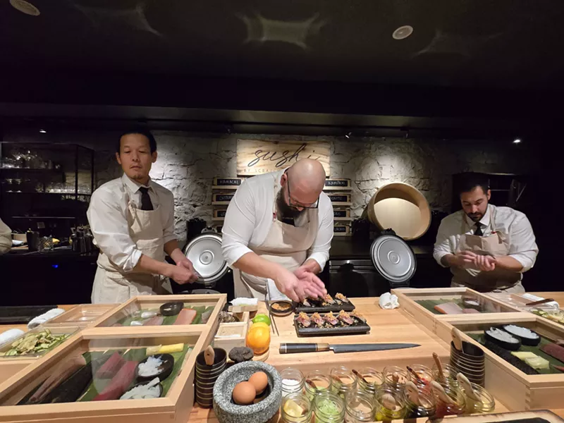 Image: chefs working behind a counter