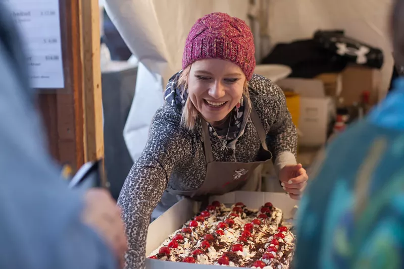 Image: woman with gifts in outside booth