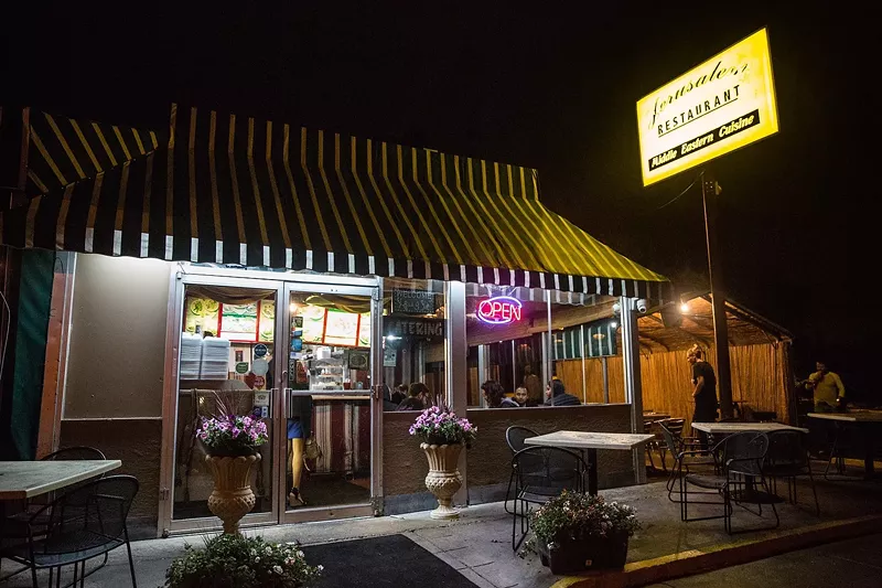 Image: the outside of a restaurant with a yellow, lit up sign